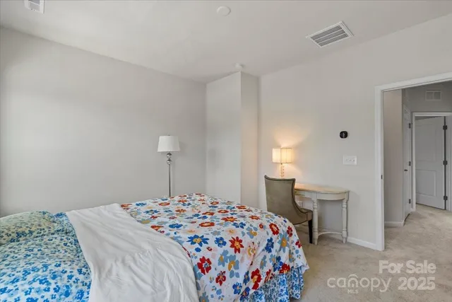 a bedroom with a bed and a lamp