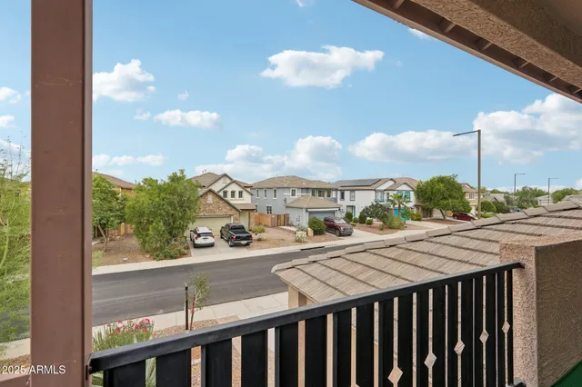 a view of a livingroom with furniture wooden floor and a ceiling fan