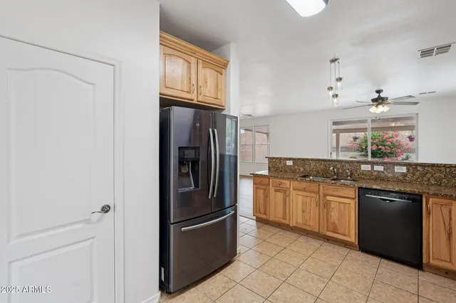 a kitchen with stainless steel appliances granite countertop a refrigerator and a sink