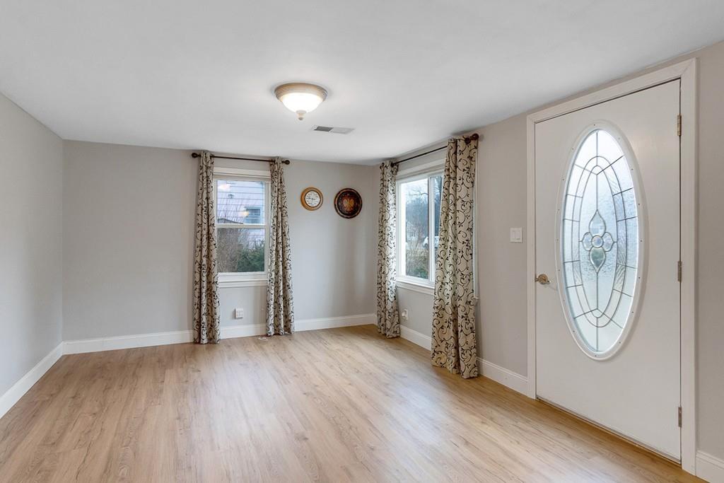 68 Lowell Road Pepperell, MA 01463 - Photo 12 of 24 an empty room with wooden floor mirror and windows