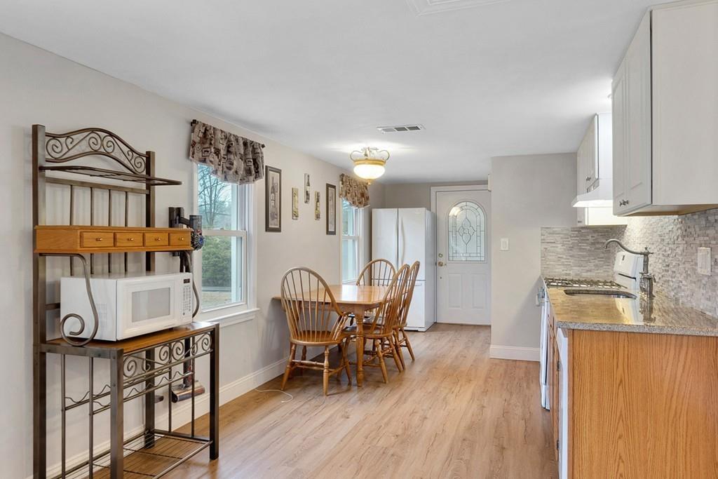 68 Lowell Road Pepperell, MA 01463 - Photo 8 of 24 a view of a dining room with furniture and wooden floor