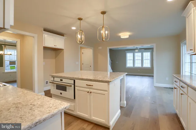 a kitchen with stainless steel appliances granite countertop wooden floors and sink