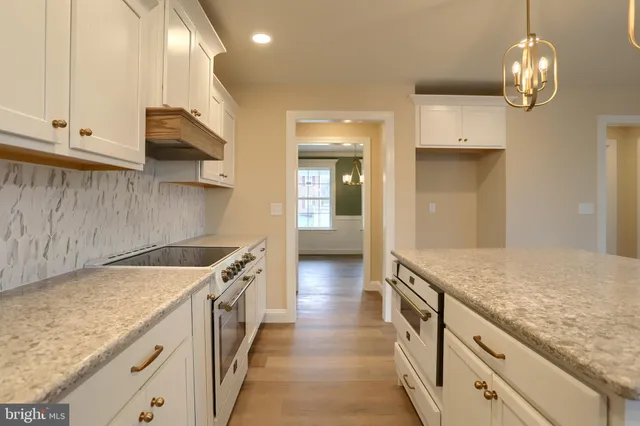a kitchen with granite countertop a sink and a stove