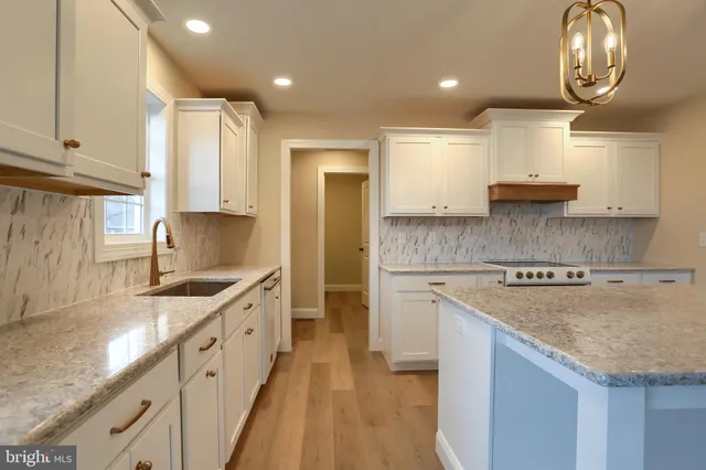 a kitchen with granite countertop a sink and a stove