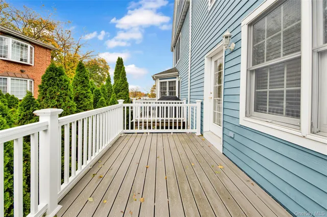 a view of a wooden deck with a yard