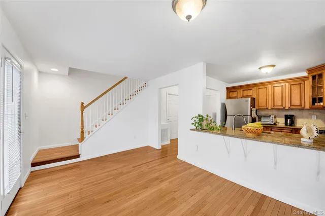 a view of a kitchen and wooden floor
