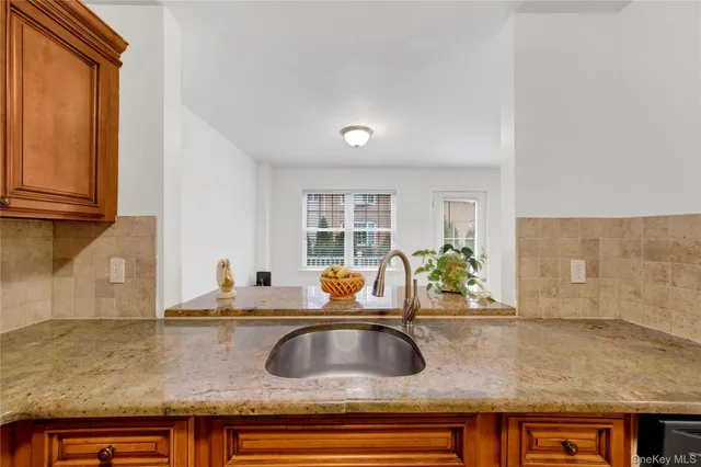 a kitchen with granite countertop a sink and a counter top space