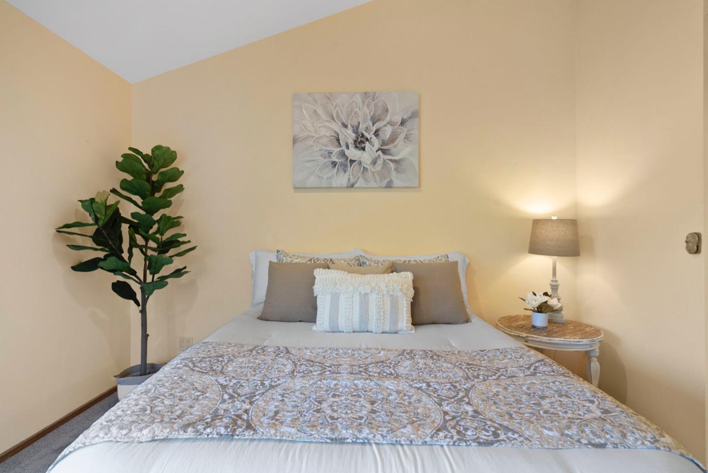 195 Raptor Road Watsonville, CA 95076 - Photo 36 of 63 a bedroom with a bed and a potted plant