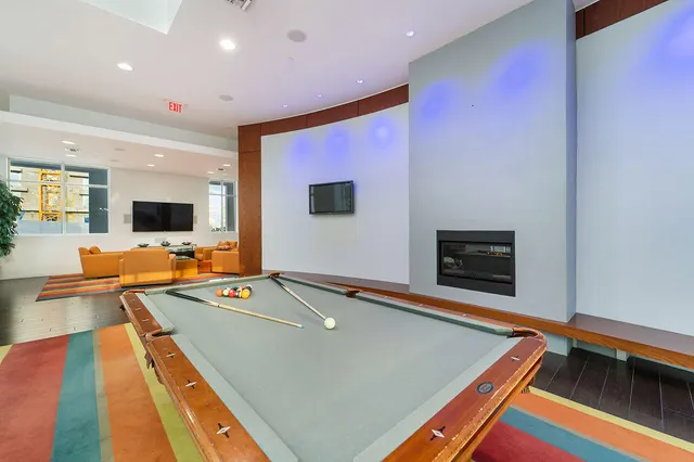 a room with pool table and a flat screen tv