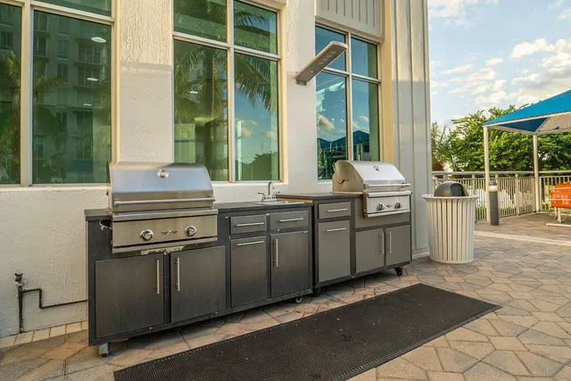a kitchen with stainless steel appliances granite countertop a stove and a sink