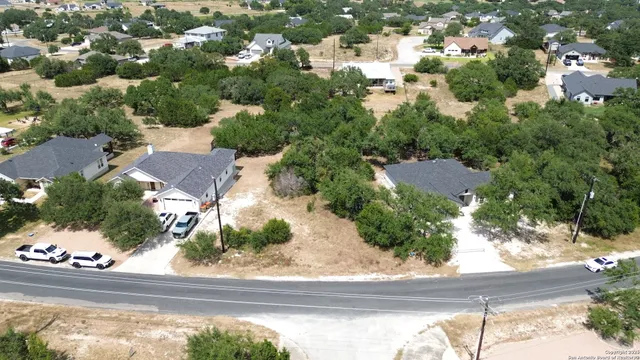 an aerial view of residential houses with outdoor space and street view