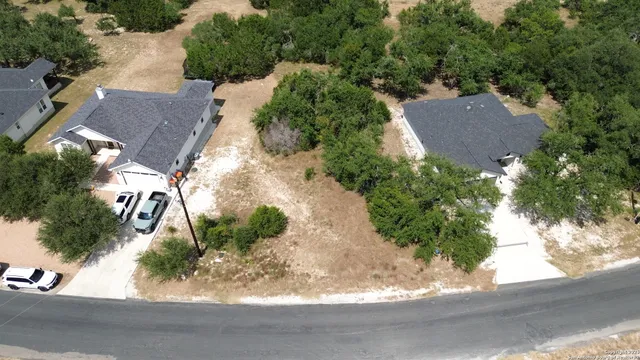 an aerial view of a house with yard and garage