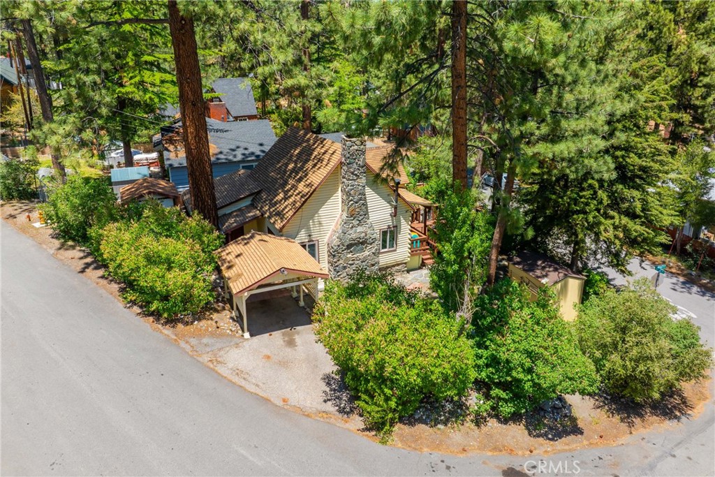 an aerial view of a house with a yard basket ball court and outdoor seating