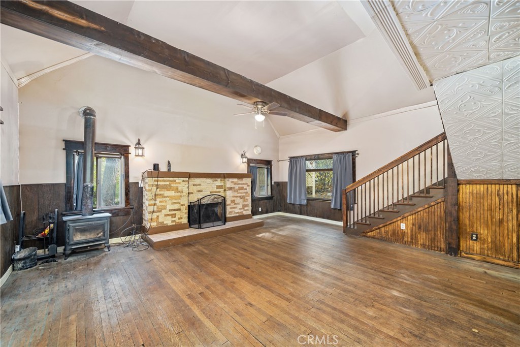 1501 Oriole Road Wrightwood, CA 92397 - Photo 7 of 29 a view of an empty room with wooden floor fireplace and a window