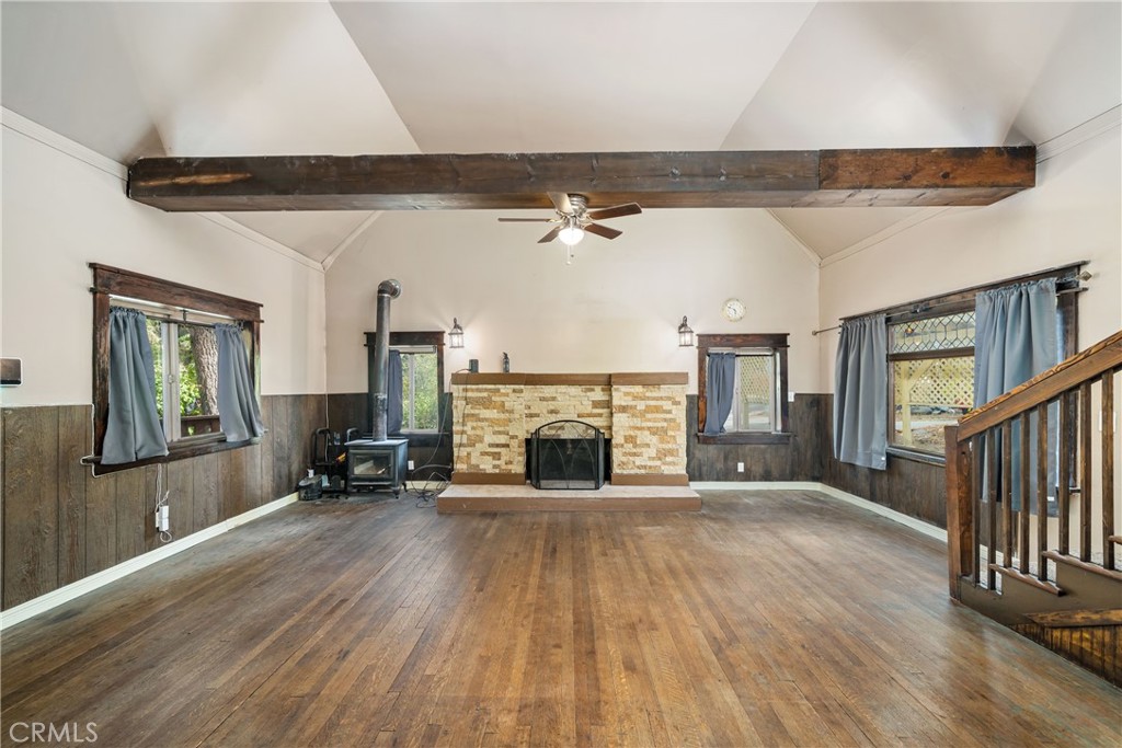 1501 Oriole Road Wrightwood, CA 92397 - Photo 9 of 29 a view of an empty room with wooden floor fireplace and a window