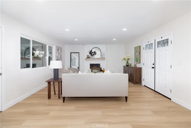a living room with furniture and a potted plant