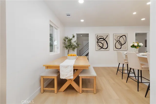 a view of dining table chairs and window