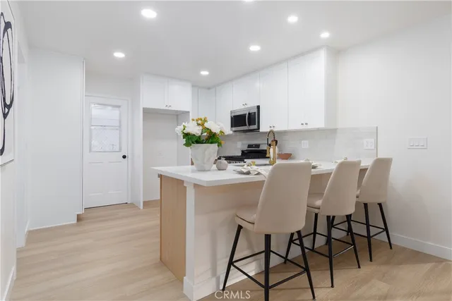 a kitchen with granite countertop a stove and a microwave