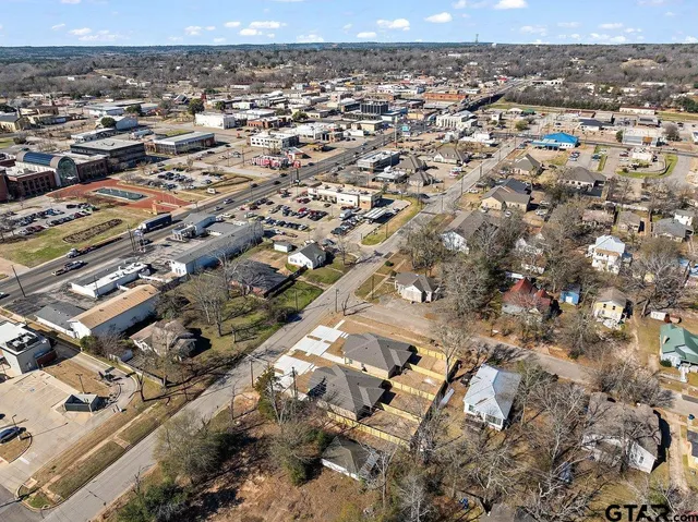 an empty room with wooden floor and a ceiling fan
