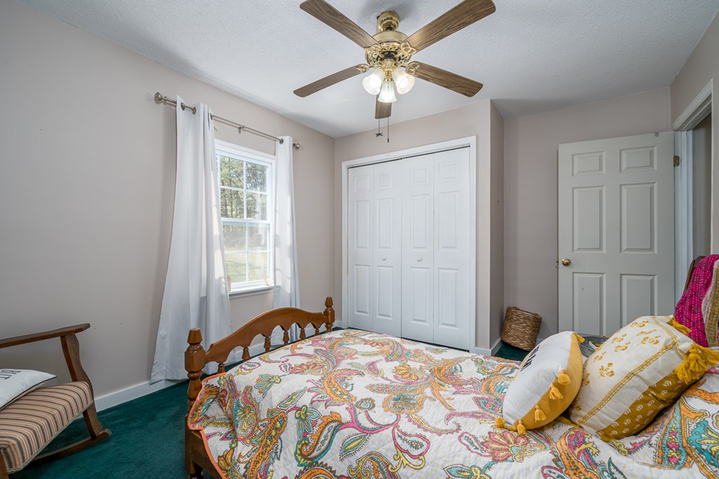 1813 John Smith Road East Blairsville, GA 30512 - Photo 21 of 41 a bedroom with a bed and a chandelier