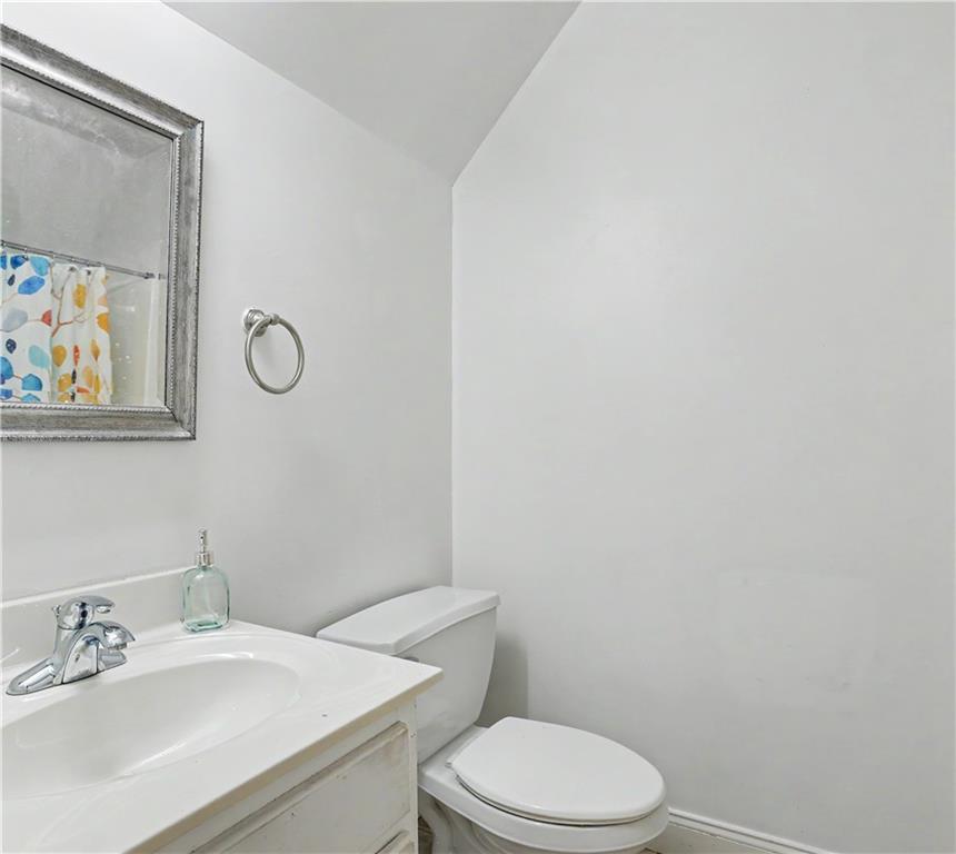 537 Old Collins Road Hoschton, GA 30548 - Photo 31 of 42 a bathroom with a sink a toilet and mirror