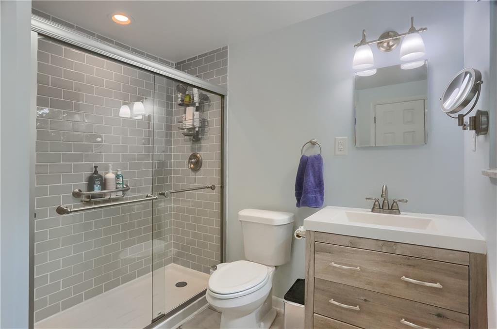 141 Ridge Avenue Pittsburgh, PA 15237 - Photo 21 of 39 An updated primary bathroom features a tile shower, a modern vanity and modern fixtures.