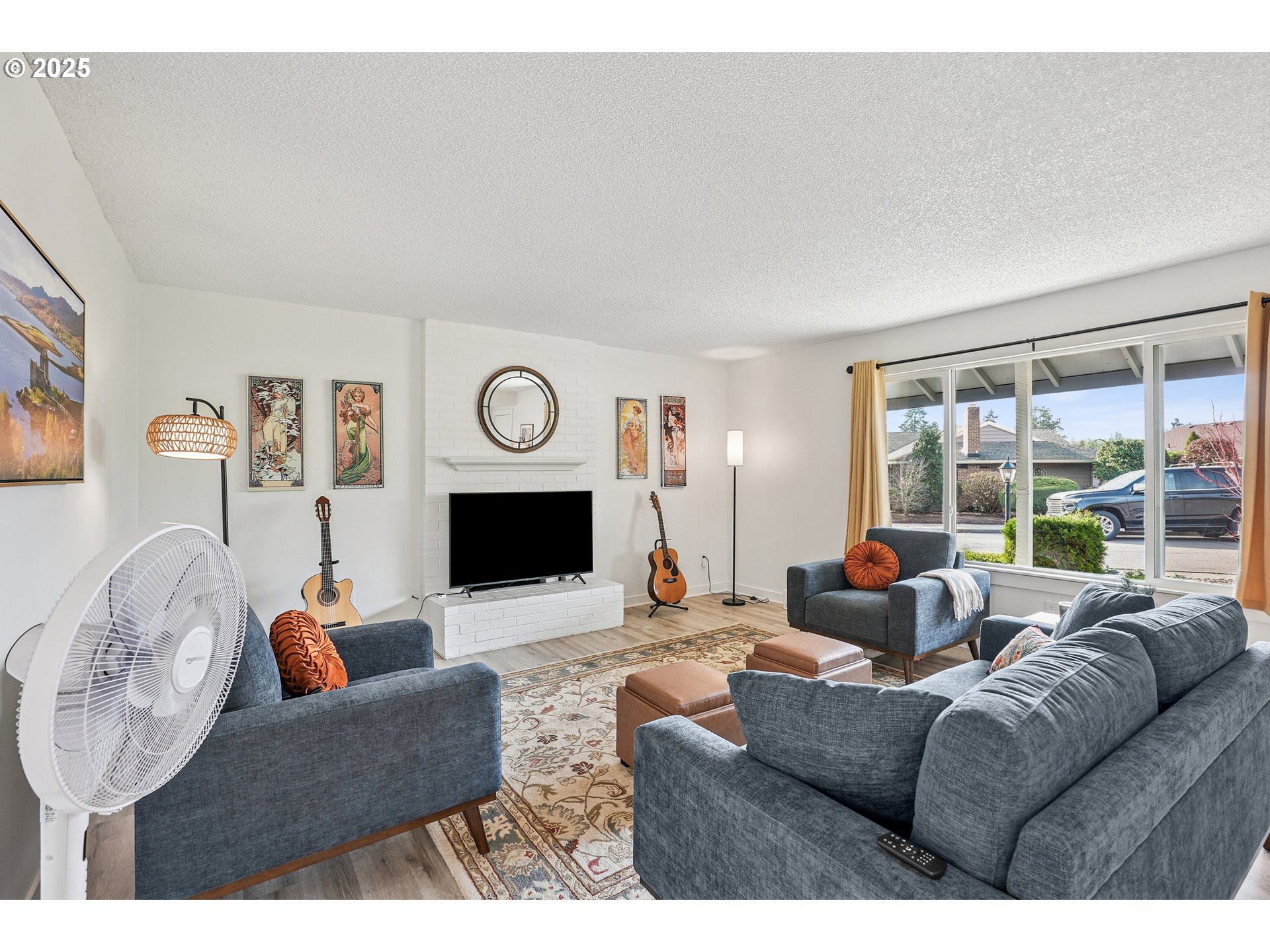 15920 Southwest Century Oak Circle Portland, OR 97224 - Photo 11 of 30 a living room with fireplace furniture and a large window