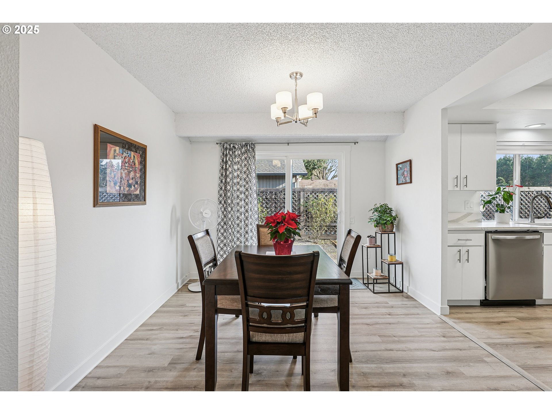 15920 Southwest Century Oak Circle Portland, OR 97224 - Photo 13 of 30 a dining room with furniture a chandelier and wooden floor