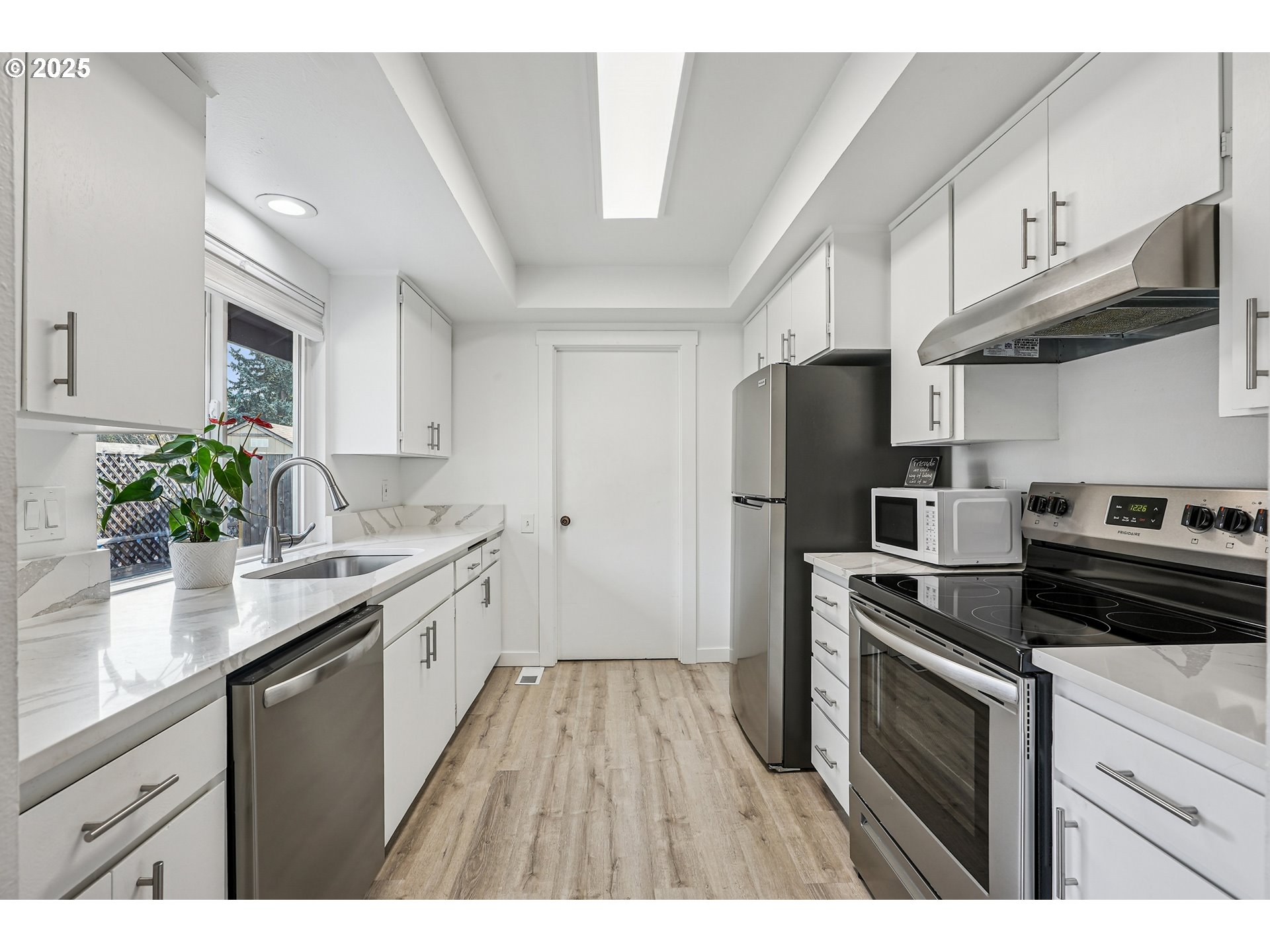 15920 Southwest Century Oak Circle Portland, OR 97224 - Photo 17 of 30 a kitchen with a sink stainless steel appliances a counter space and cabinets