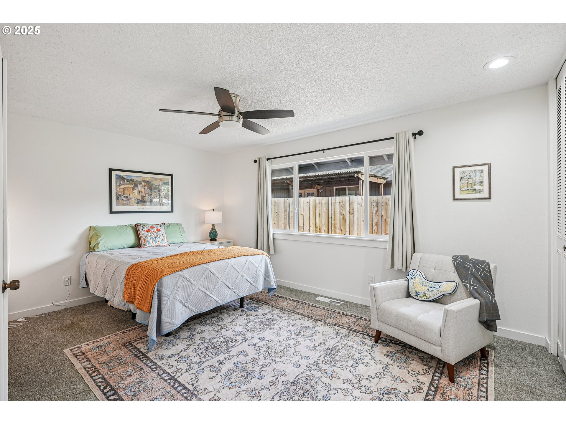15920 Southwest Century Oak Circle Portland, OR 97224 - Photo 22 of 30 a spacious bedroom with a bed and glass window