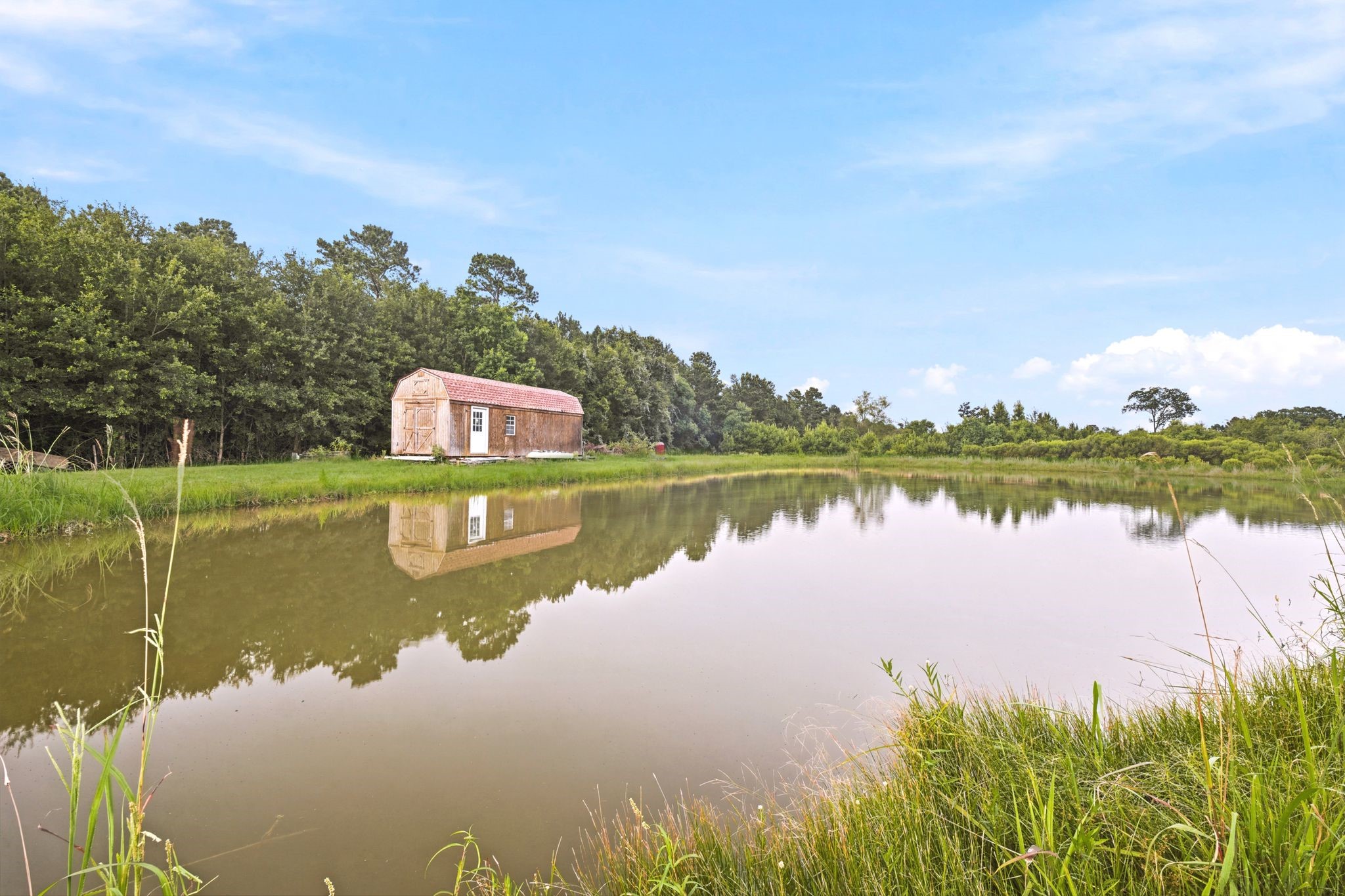 144 Wood Farm Road Huntsville, TX 77320 - Photo 41 of 50 a view of a lake with houses in the back