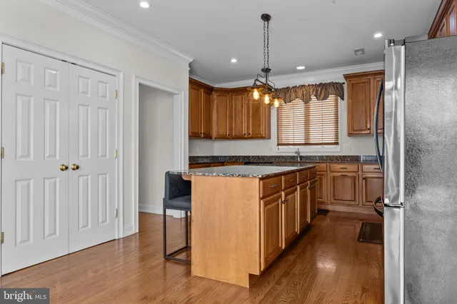 a kitchen with stainless steel appliances granite countertop a stove and a refrigerator
