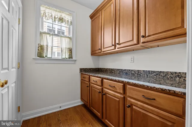 a kitchen with granite countertop white cabinets and white appliances