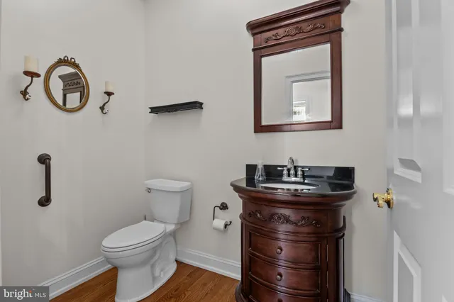 a bathroom with a toilet a sink and mirror