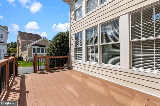 a view of a house with a balcony and wooden fence