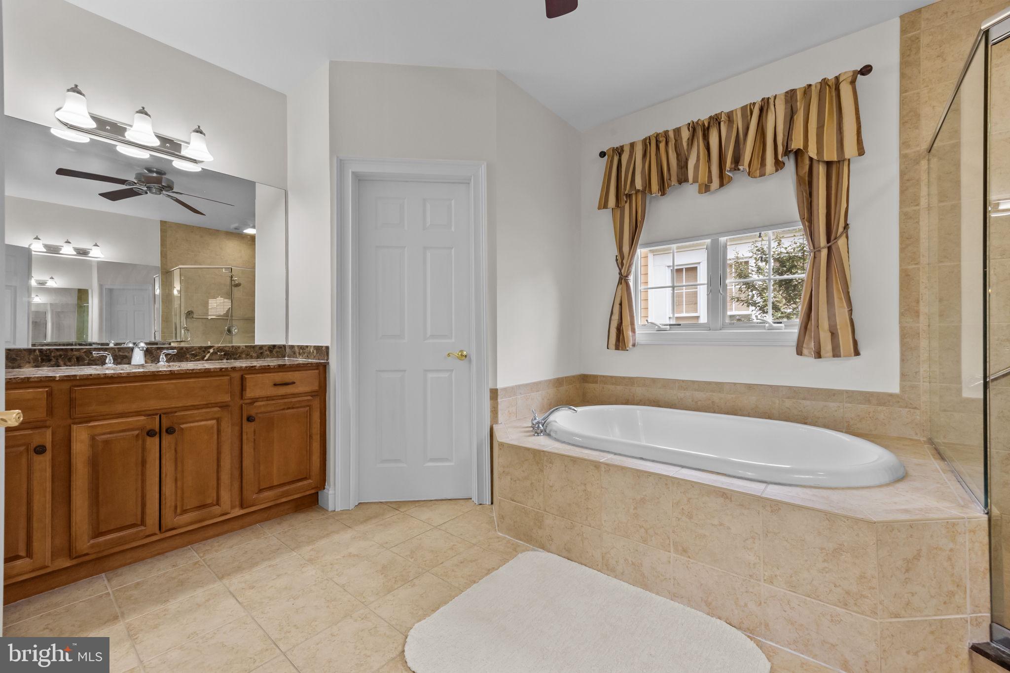 3541 Reading Way Huntingdon Valley, PA 19006 - Photo 32 of 54 a spacious bathroom with a granite countertop tub sink and mirror