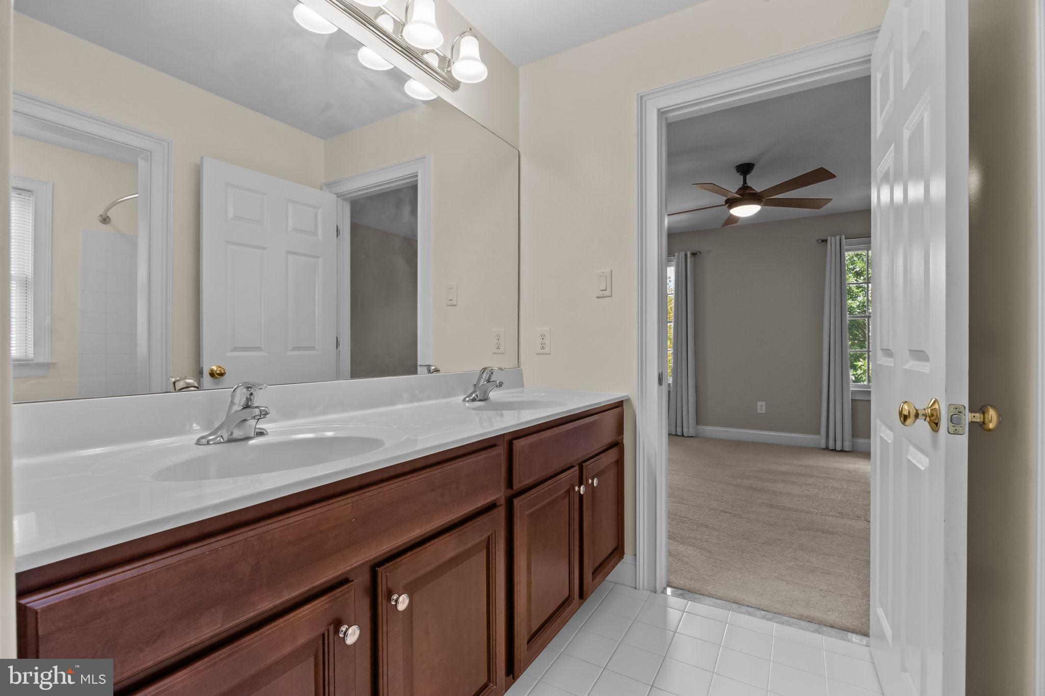 3541 Reading Way Huntingdon Valley, PA 19006 - Photo 36 of 54 a bathroom with a sink a large mirror and a shower