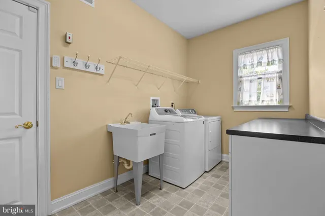 a view of staircase with railing and white walls