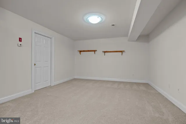 a view of empty room with wooden walls