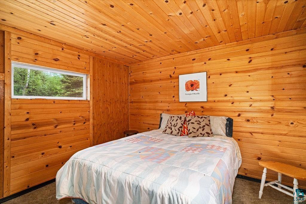 1268 Tom Lake Road Hovland, MN 55606 - Photo 18 of 56 Interior room featuring extensive wood paneling on walls and ceiling