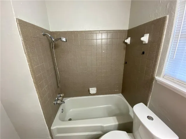 a bathroom with a tub and shower