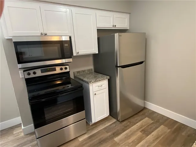 a kitchen with a stove microwave and refrigerator
