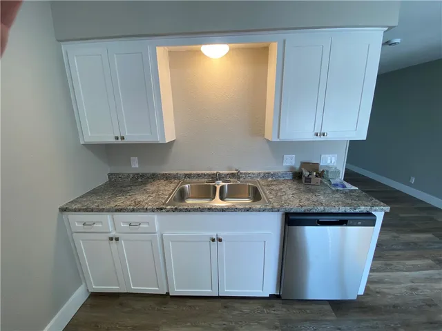 a kitchen with granite countertop cabinets and sink