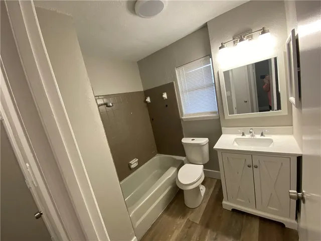 a bathroom with a sink and mirror with toilet