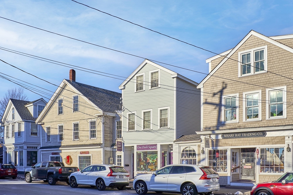 1 Dock Square Rockport, MA 01966 - Photo 3 of 34 a front view of a building with cars parked
