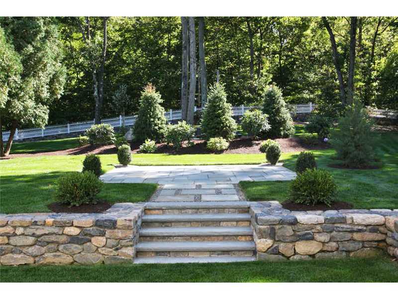 717 Riversville Road Greenwich, CT 06831 - Photo 12 of 24 a view of swimming pool with a garden and trees