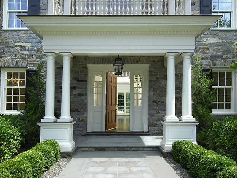 717 Riversville Road Greenwich, CT 06831 - Photo 4 of 24 a front view of a house with a garden