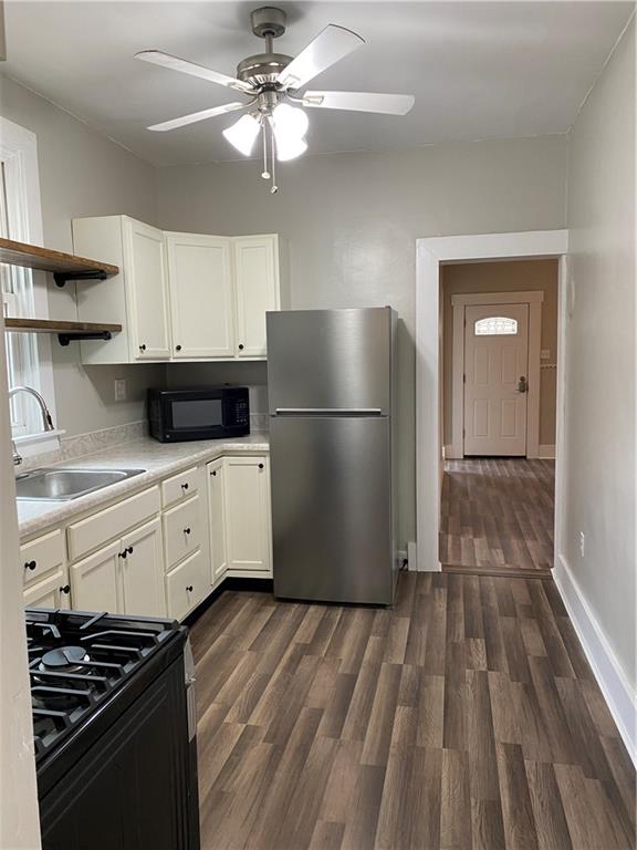 238 Hickory Street McKees Rocks, PA 15136 - Photo 7 of 18 a kitchen with granite countertop a refrigerator and a stove top oven