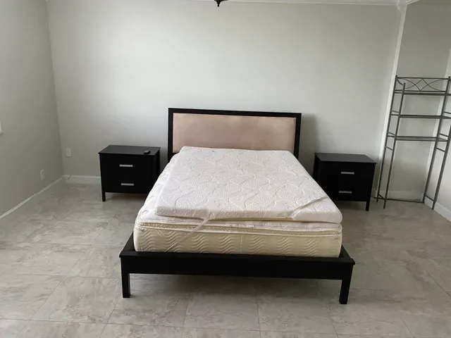 a bed sitting in a bedroom next to a window