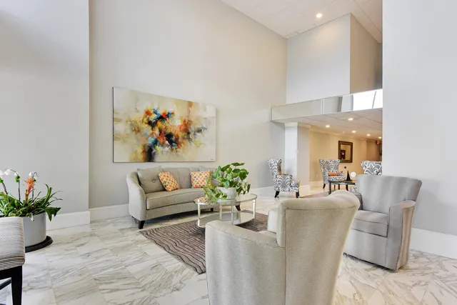 a living room with furniture potted plant and a window